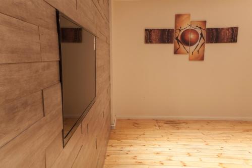 a room with a wall with a mirror and a painting at Best City Home Near Checkpoint Charlie in Berlin