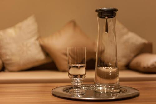 a bottle of water and a glass on a table at Best City Home Near Checkpoint Charlie in Berlin