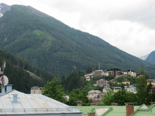 a town in front of a mountain with houses at Club Alpenresidenz Gastein in Bad Gastein