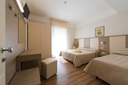 En eller flere senge i et værelse på Hotel Giulietta