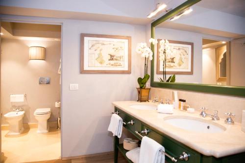 a bathroom with a sink and a toilet and a mirror at Al Palazzo del Marchese di Camugliano Residenza d'Epoca in Florence