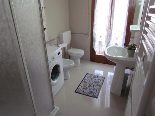 a bathroom with a toilet and a sink and a shower at Siviero Apartments in Scardovari