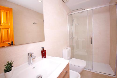 a bathroom with a toilet and a sink and a shower at Lighthouse View II in Santa Pola