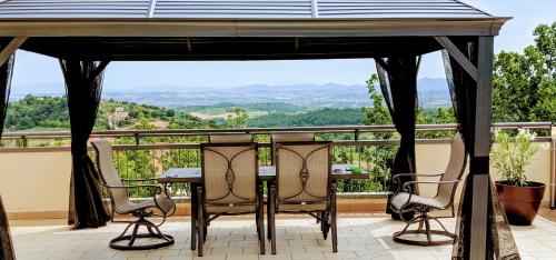 a gazebo with chairs and a table on a patio at Arts Club Suite & Spa in Chianciano Terme