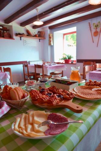 a table topped with plates of food on a table at Agriturismo Pian dei Tass in Barcis