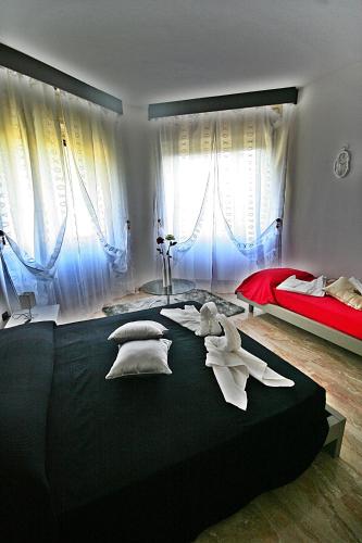 a bedroom with a large black bed with pillows at Villa Harriet in Sovere