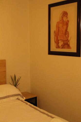 a picture of a woman on a wall next to a bed at Hospedaje Donaji in Oaxaca City