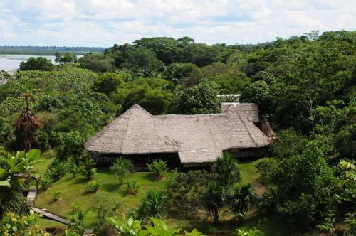 an old house with a straw roof in the forest at Pacaya Samiria Amazon Lodge - ALL INCLUSIVE in Nauta