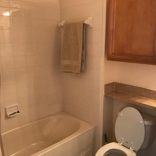 a bathroom with a tub and a toilet and a sink at Serenata Condominiums,Sarasota in Sarasota