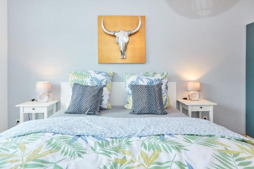 a bedroom with a bed with pillows and a picture of a skull at Ferienwohnung Bella Vista in Bernkastel-Kues