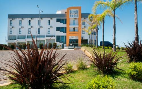 CaçadorにあるBrivali Hotel e Eventosの目の前にヤシの木があるホテル