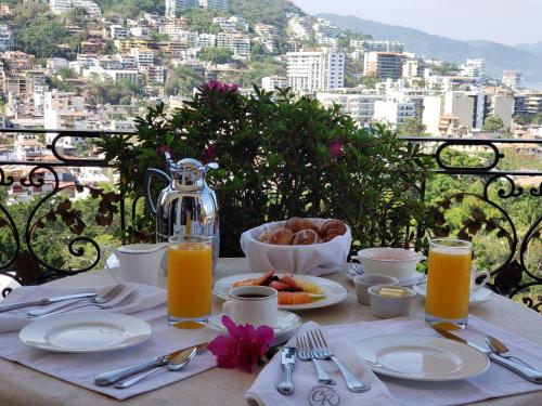 a table with food and a view of a city at Casa Kimberly Boutique Hotel in Puerto Vallarta