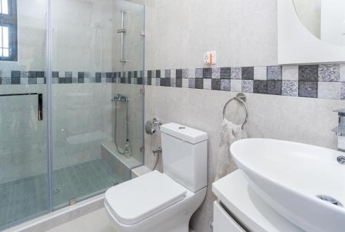 a bathroom with a toilet and a shower and a sink at Seasonal Villa in Flic-en-Flac