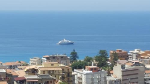 a cruise ship in the water with buildings at Appartamenti Borgo Panoramico N 5 in Tropea