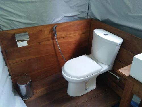 a small bathroom with a toilet in a tent at Makulu Safari Camping in Udawalawe
