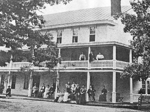 a group of people standing on the balcony of a house at Highlands Inn in Highlands