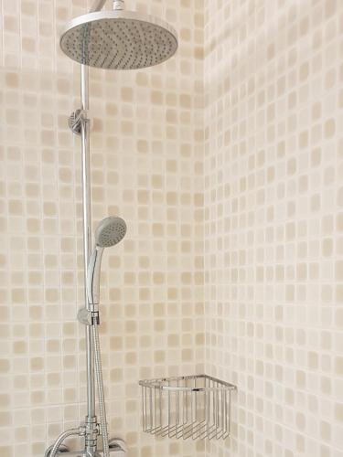 a shower with a shower head in a bathroom at LUNA SON BOU in Son Bou