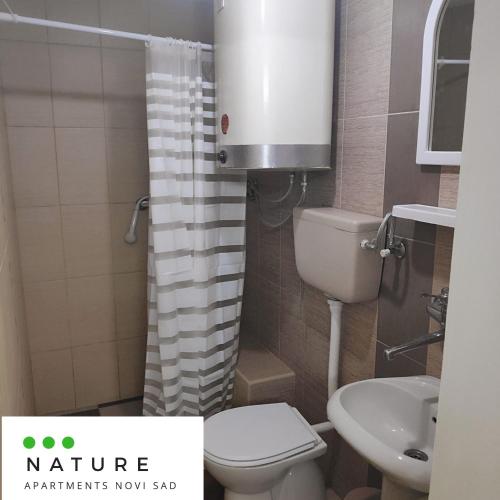 a small bathroom with a toilet and a sink at Just nature in Novi Sad