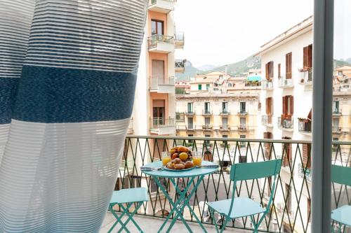 a table with a bowl of fruit on a balcony at Velia34 in Salerno
