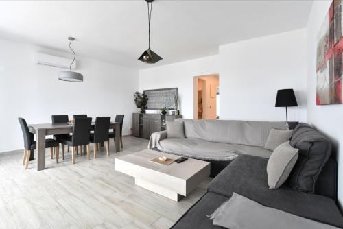 a living room with a couch and a table at Parikias Seaside House in Kampos Paros