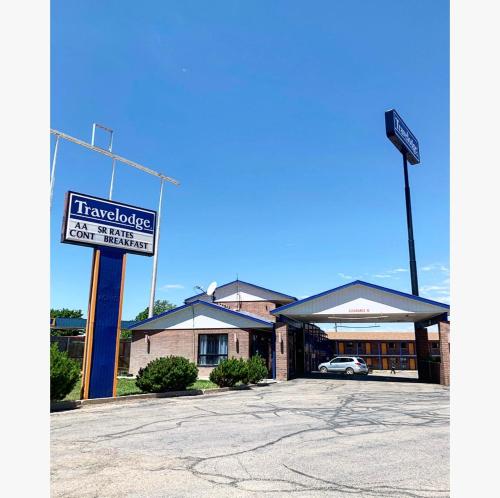 a hotel with a sign in front of a building at Travelodge by Wyndham Cedar City in Cedar City