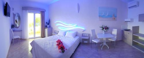a bedroom with a bed and a table and chairs at Studios & Appartments Posidonio in Klíma