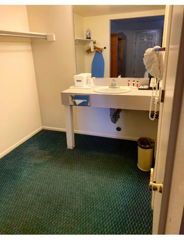 a bathroom with a sink and a mirror at Travelodge by Wyndham Cedar City in Cedar City