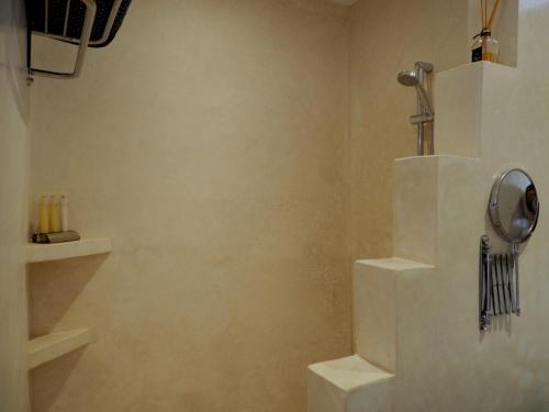 a bathroom with white stairs and a shower at Dar Tifrouine in Lalla Takerkoust