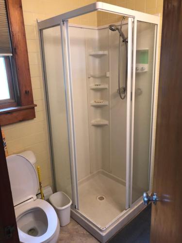 a shower stall in a bathroom with a toilet at Welcome to the Lake in Northwood