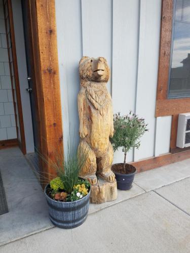 a statue of a bear sitting outside of a building at 406 Lodge at Yellowstone in Gardiner