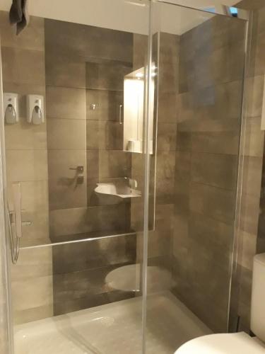 a bathroom with a shower with a sink and a toilet at Palaiokastro view in Karpathos Town