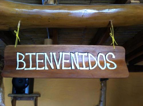 a sign that says benedictions hanging from a ceiling at Hostal Rutamar in Canoa