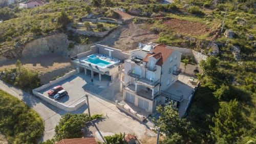 an aerial view of a house with a swimming pool at Apartments Pušić in Omiš