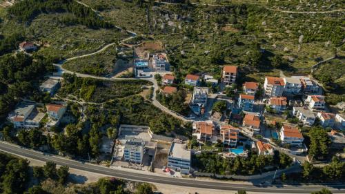 an aerial view of a city with houses and a road at Apartments Pušić in Omiš