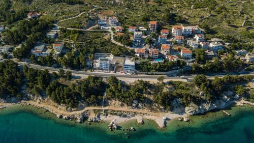 an aerial view of a resort near the ocean at Apartments Pušić in Omiš