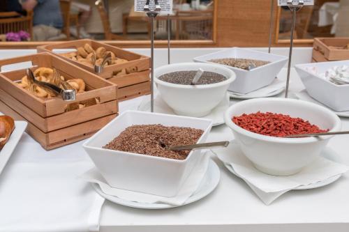 a table topped with bowls of spices and other dishes at Apollo Beach in Faliraki