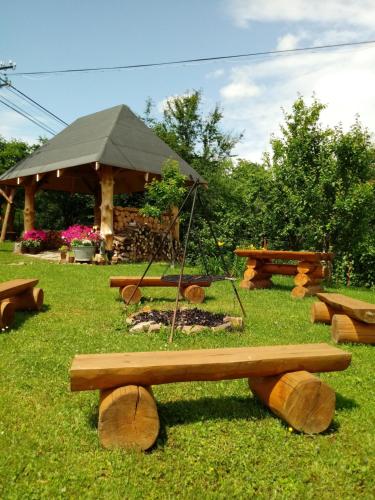 a group of picnic tables and a tent in a park at Dom Gościnny BIERWIONO in Cisna