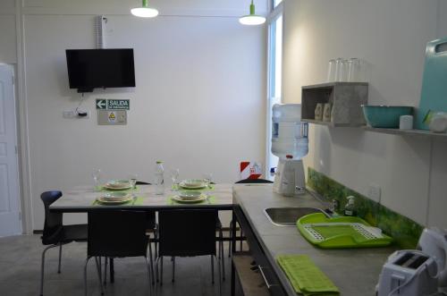 a kitchen with a table with chairs and a sink at Entre Acequias in General Alvear