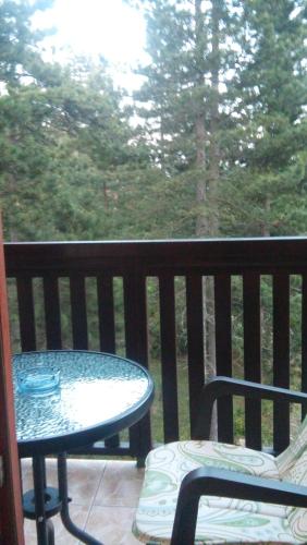 a table and chairs on a balcony with a table and a window at Apartmani Sredojevic in Kaludjerske Bare