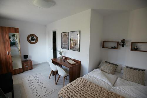 a bedroom with a bed and a desk and a bed and a desk at Siedlisko Vincent in Szydłów