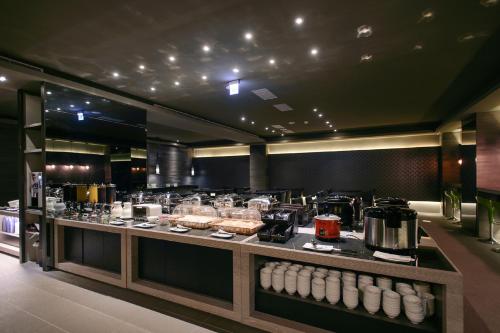 a kitchen with a buffet of food on display at Kiwi Express Hotel - Jiuru Rd in Kaohsiung