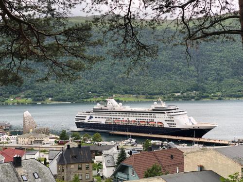 a cruise ship is docked in the water at Åndalsnes Apartments - Luxury Stay in Åndalsnes