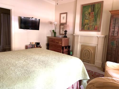 a bedroom with a bed and a fireplace at Terrell House Bed and Breakfast in New Orleans