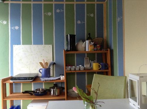 a room with green and blue striped walls and a book shelf at Bauwagen Villa Frederik in Radebeul