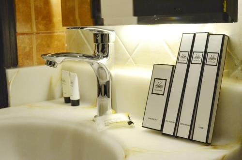 a bathroom sink with a faucet and books on it at مشارف الفخامة أبها in Abha
