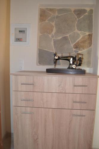 a sewing machine sitting on top of a wooden cabinet at Elafonisi House in Livadia