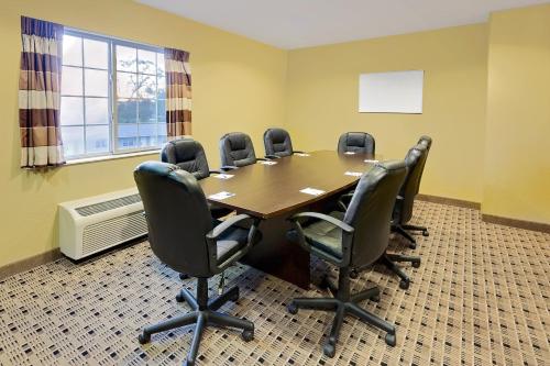a conference room with a wooden table and chairs at Microtel Inn & Suites by Wyndham Prairie du Chien in Prairie du Chien