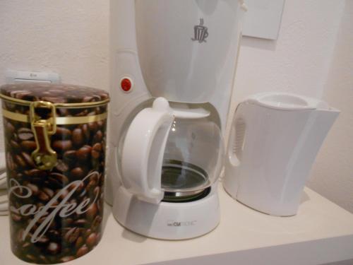 a coffee maker and a container of coffee beans at Apartment Beethoven in Regensburg