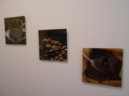 three pictures of nuts and a cup of coffee on a wall at Apartment Beethoven in Regensburg