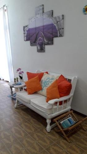 a white couch with colorful pillows in a living room at 4 stagioni in Villasimius